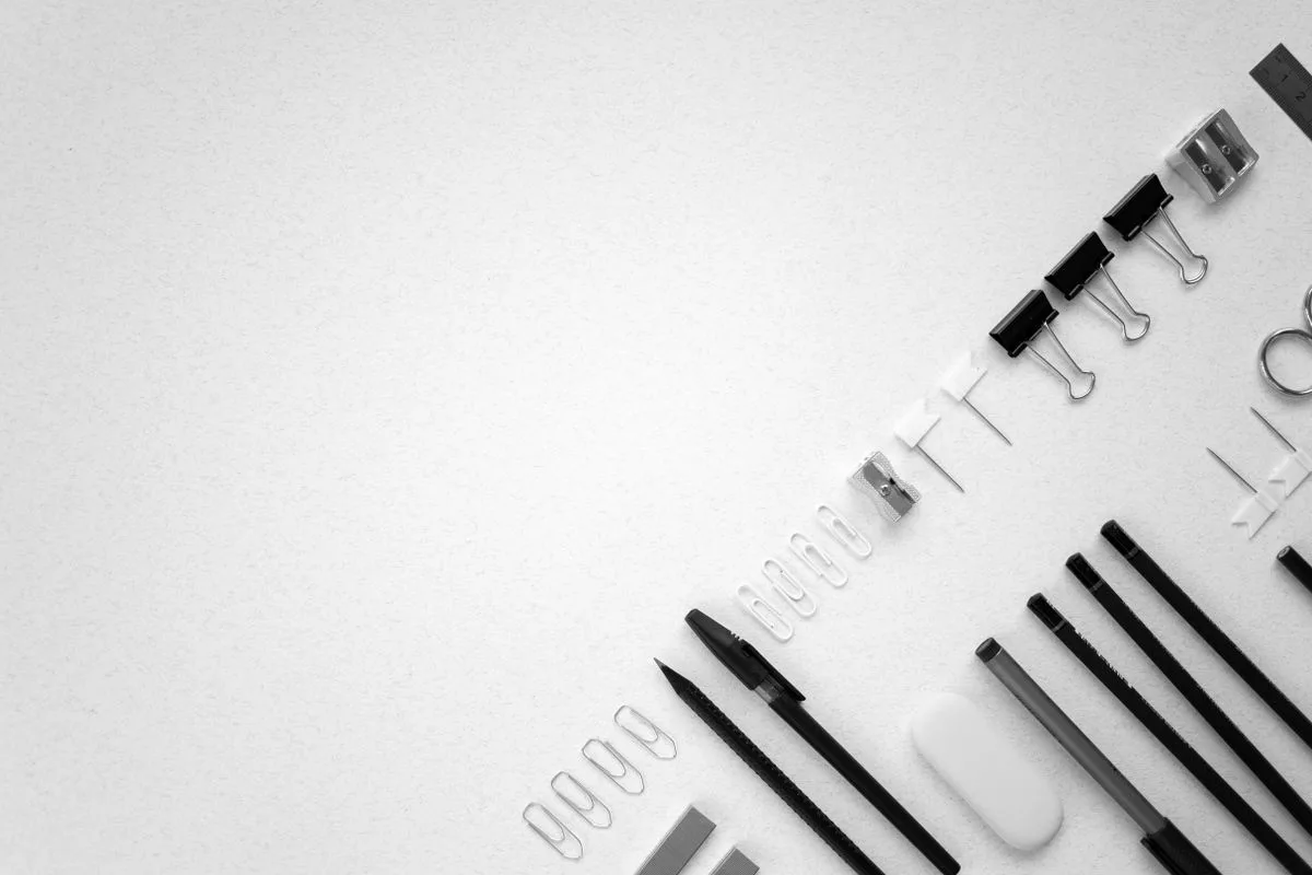 Office clips and filing supplies arranged on a white background